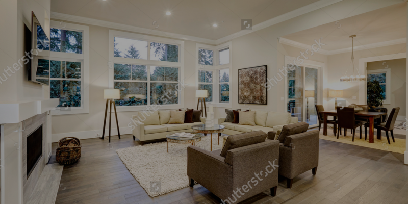 stock-photo-chic-light-living-room-design-with-dark-floors-furnished-with-glass-top-accent-tables-and-beige-557475709